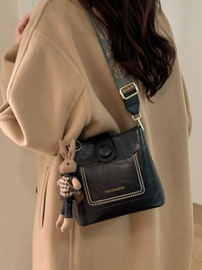Black PU leather shoulder bag with ethnic style wide strap and rabbit pendant