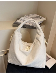 Minimalist white tote bag with large capacity and multi-zipper detail in soft nylon fabric