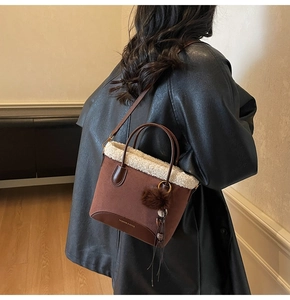 Sac à main en daim marron et imitation mouton avec un charm décoratif en pompon doux
