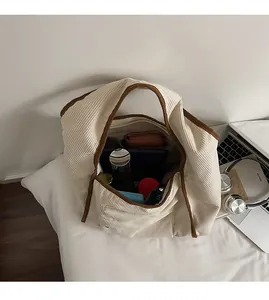 Detail view of the spacious inner storage of this cream corduroy tote bag for daily essentials