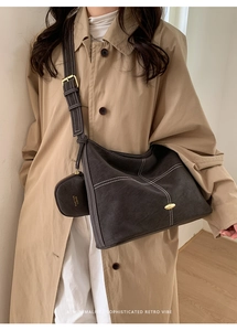 Detail of retro leather tote bag with white contrast stitching and mini coin purse