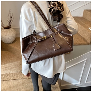 Chocolate brown tote bag featuring contrast stitching and vintage faux leather texture