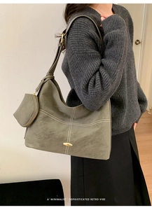 Close-up of olive green tote bag featuring white stitching and attached coin purse