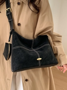 Retro black matte tote bag with contrast stitching and small pouch shown on model