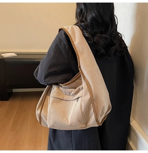 Detail of soft corduroy fabric texture and large capacity of this beige tote bag