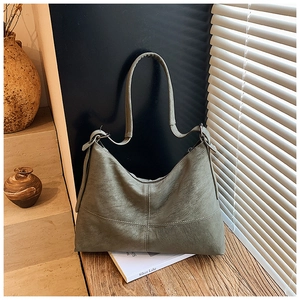 Detail of olive green hobo bag featuring matte faux leather and contrast stitching