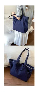 Macro detail of navy blue tote bag featuring functional side drawstring pockets and durable fabric