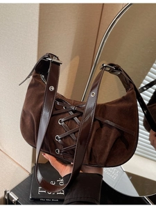 Brown suede half-moon underarm bag with vintage lace-up detail and mirror prop
