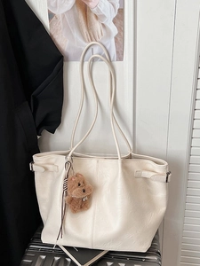 Minimalist beige suede tote bag with cute brown bear charm for casual winter style