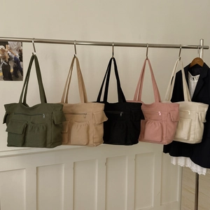 Detailed display of multi-pocket corduroy tote bags in five various classic colors