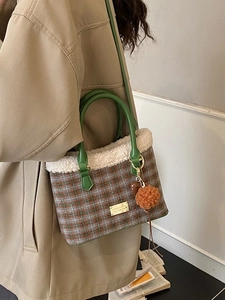 Women's plaid bucket bag with plush trim and green leather handles for winter