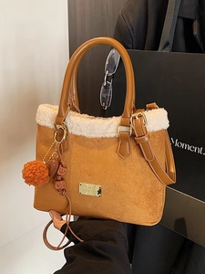 Brown suede bucket bag with white faux fur trim and colorful decorative charms