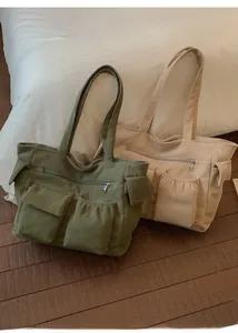 Detailed view of corduroy tote bags with multi-pockets in olive green and beige colors