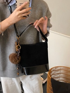 Minimalist large black suede bucket bag with decorative plush charm for women