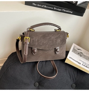 Macro detail of dark brown retro textured leather on minimalist crossbody bag