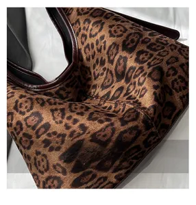 Close-up of leopard print tote bag featuring soft suede texture and brown leather piping