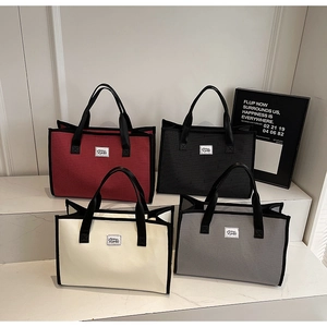 Detailed set of large plaid tote bags in burgundy, black, cream, and grey colors