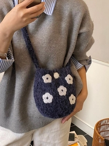 Cute navy blue plush bucket bag with white floral embroidery and soft knit texture
