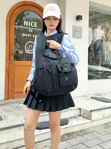 Chic black pleated nylon backpack with a multi-pocket design and adjustable shoulder straps