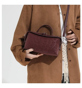 Detail showing the burgundy faux suede leopard print handbag with silver-tone hardware
