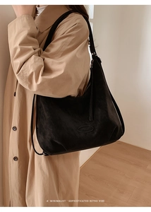 Detail of minimalist black suede tote bag showing large capacity and soft vintage texture