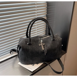 Dettaglio borsa Boston scamosciata grigio scuro con croce in metallo e manici tondi