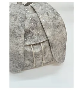 Detail of grey backpack with rabbit ear flap and silver star studs showing drawstrings
