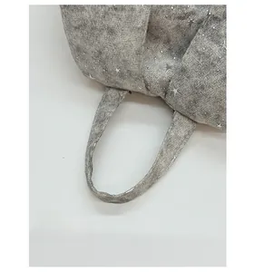 Close-up of comfortable grey tote handle with silver star print and fine fabric texture