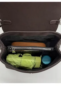 Top view of spacious interior with laptop, umbrella, and zip pocket in dark brown leather bag