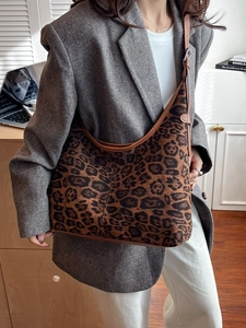 Leopard print crossbody tote bag with brown faux leather trim and adjustable strap