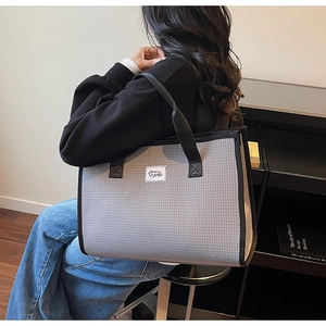 Détail du grand sac cabas à carreaux gris et blanc avec bandoulières noires pour femme