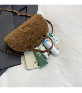 Spacious interior of brown teddy fleece crossbody bag showing large storage capacity