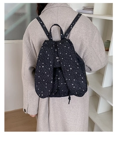 Detail of blue canvas backpack with white stars and cute long rabbit ear flap design