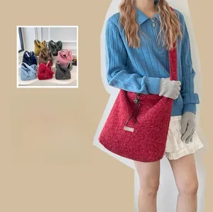 Macro view of plush textured bucket bag with drawstring detail and metallic eyelets
