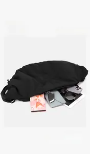 Spacious interior of black nylon crossbody bag showing storage capacity for daily essentials