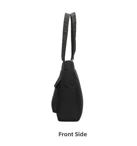 Side view of a black minimalist tote bag showing thickness and side pocket details