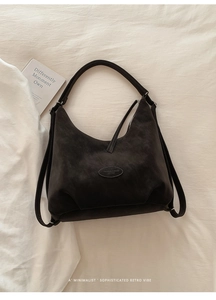 Detailansicht der braunen Vintage-Wildleder-Hobo-Tasche mit ovalem Logo-Lederetikett