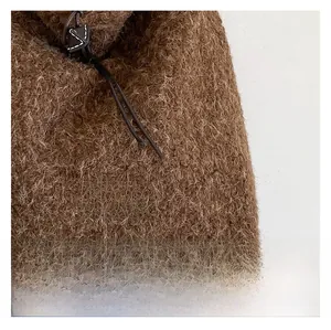 Detail of dark brown faux shearling tote bag with our fave leather label and drawstring