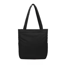 Back view of a large black minimalist tote bag with side pockets and long shoulder straps