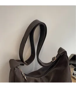 Detail of adjustable long shoulder strap and contrast stitching on coffee tote bag