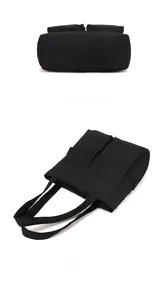 Flat lay and bottom view of minimalist black nylon tote bag with two utility pockets
