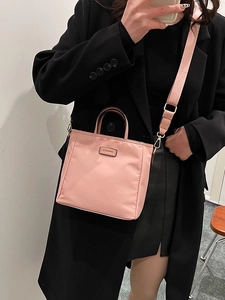 Pink nylon tote bag with leather logo patch and matching wide shoulder strap for women