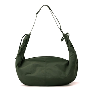 Detail of army green nylon crescent bag featuring ruched drawstring shoulder strap