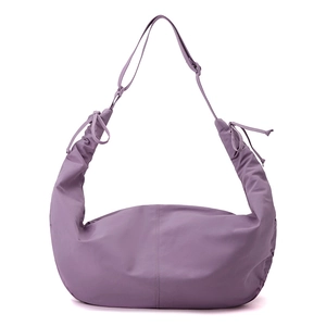 Detail of purple nylon crescent bag featuring side drawstring ruching and adjustable strap
