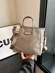 Khaki nylon tote bag with leather handles and wide shoulder strap for women