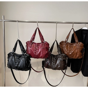 Detailed display of vintage punk tote bags with lace-up straps and rivet accents in four colors