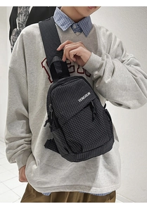 Close-up of checkered crossbody chest bag with TENGRUN logo and adjustable strap