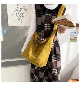 Detail of yellow fuzzy plush tote bag with our fave leather patch and plaid drawstring liner