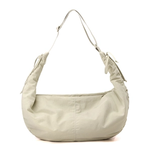 Detail of adjustable wide shoulder strap and drawstring pleats on nylon hobo bag