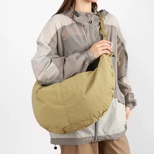 Detailed view of the olive green nylon crescent bag with adjustable wide shoulder strap